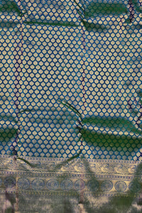 Close-up of a blue fabric with gold geometric pattern