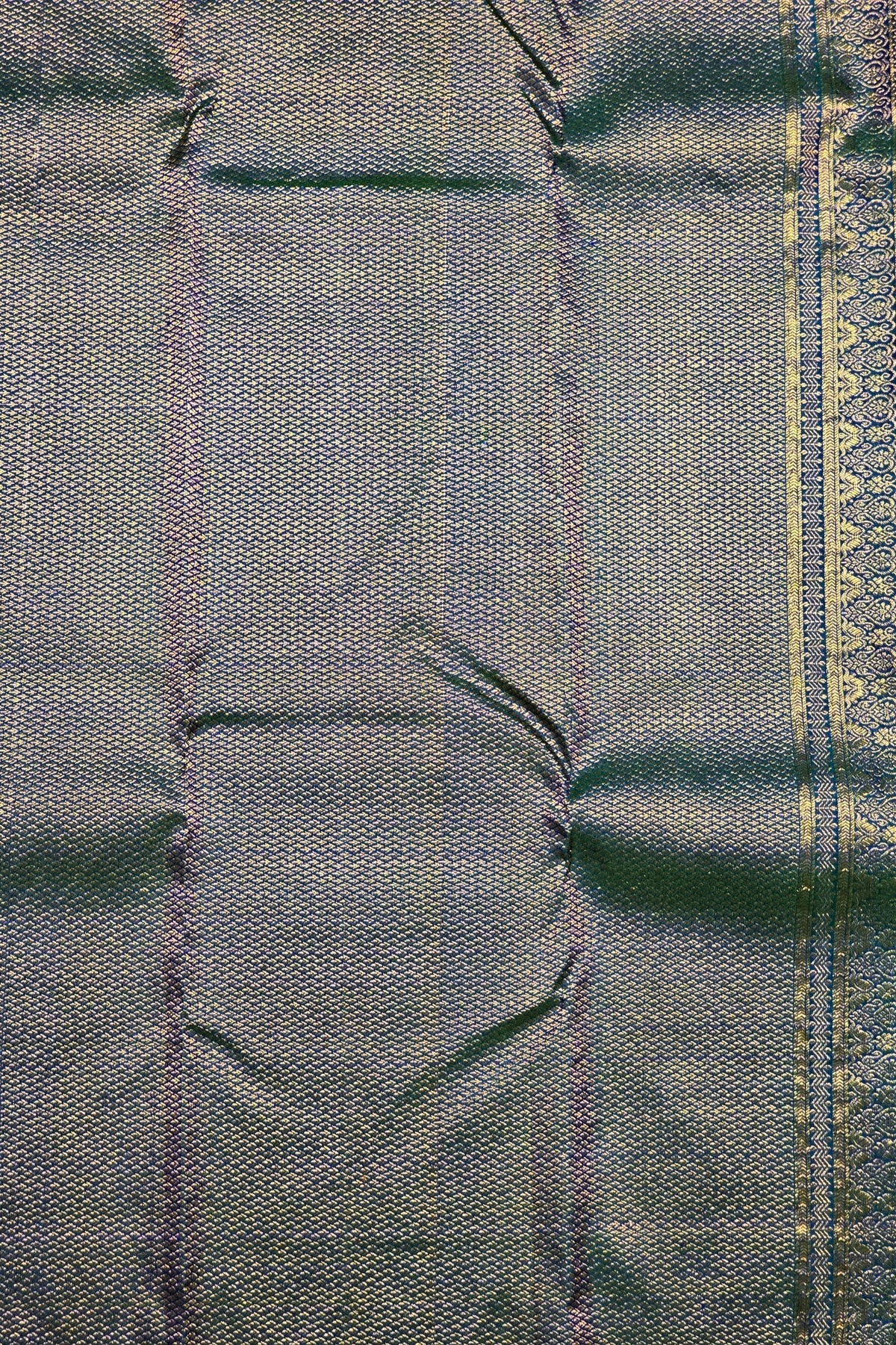 Close-up of a textured fabric with a patterned border