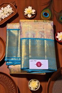 Saree with blue border on a wooden surface with decorative elements