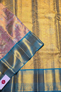 Gold saree with blue border and intricate patterns on a textured background