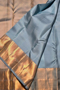 Fabric with blue and gold pattern on a wooden surface
