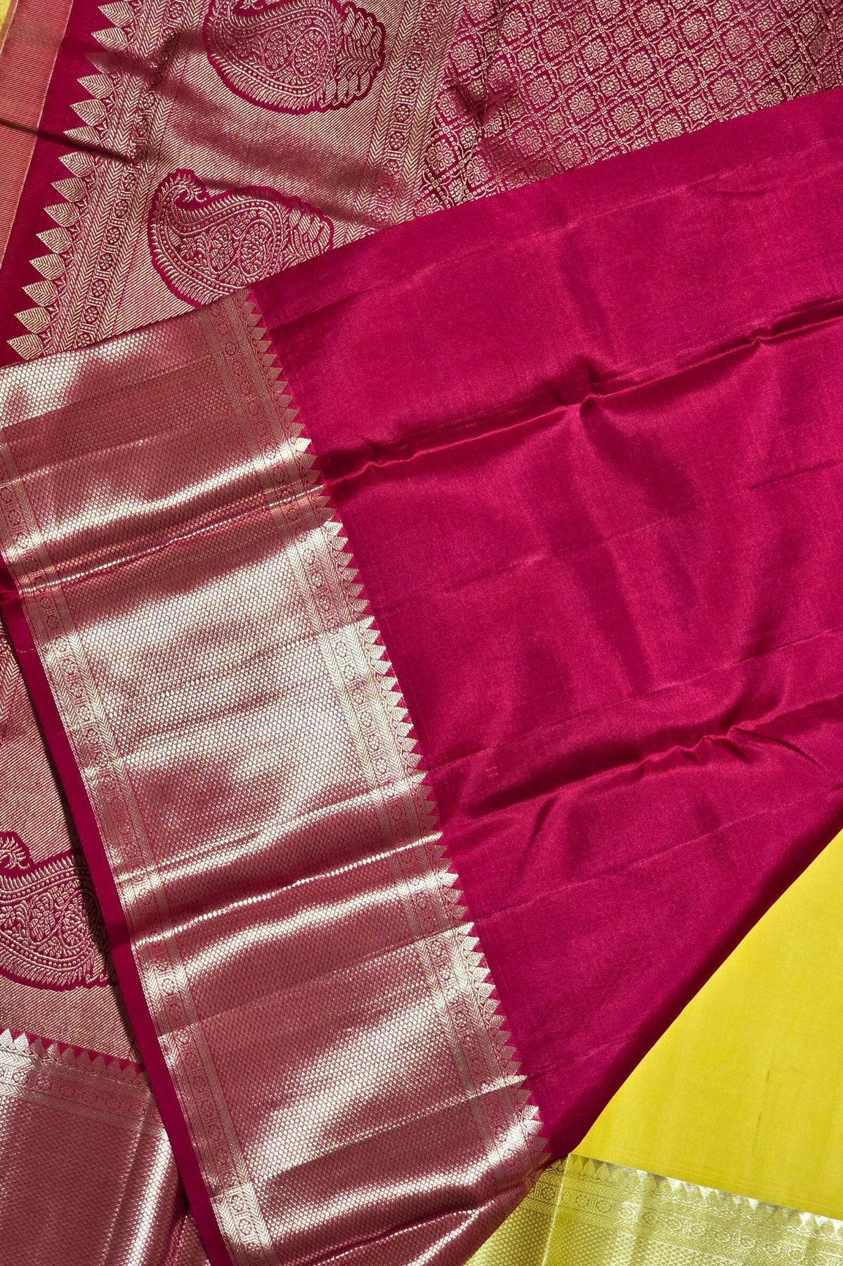Close-up of a pink saree with a yellow border