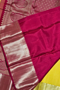 Close-up of a pink saree with a yellow border