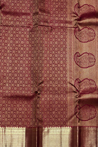 Maroon fabric with intricate patterns and designs