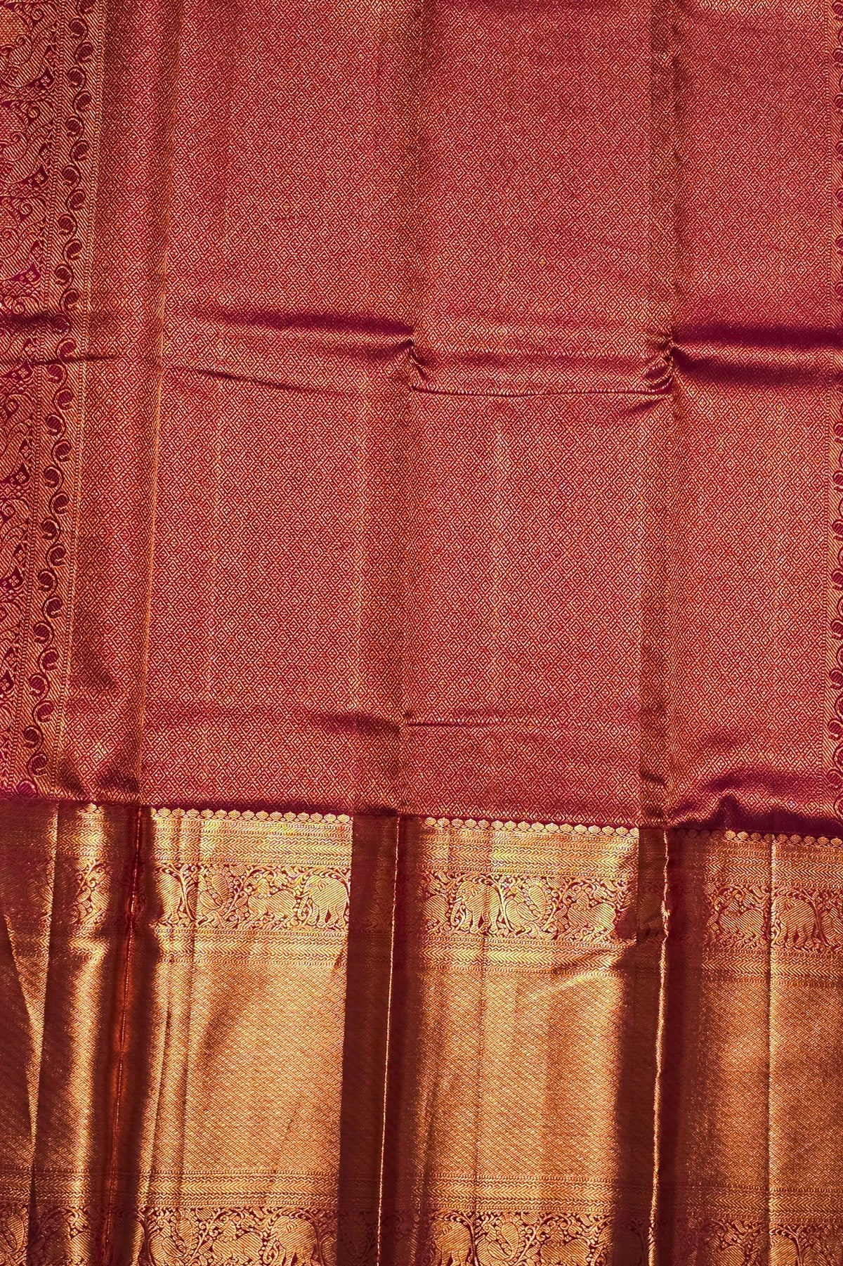 Maroon saree with gold border and patterns