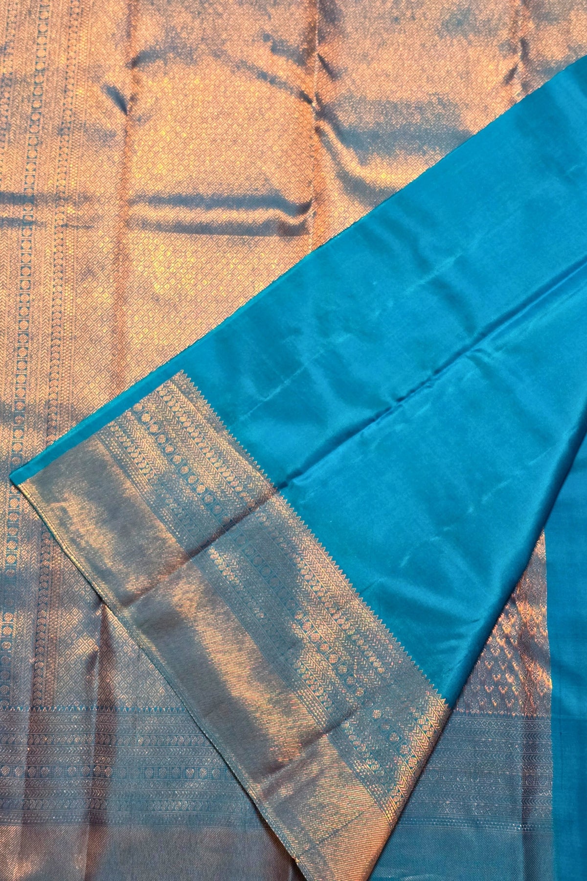 Close-up of a blue fabric with a textured pattern on a textured background
