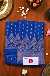 Blue saree with white patterns on a wooden surface