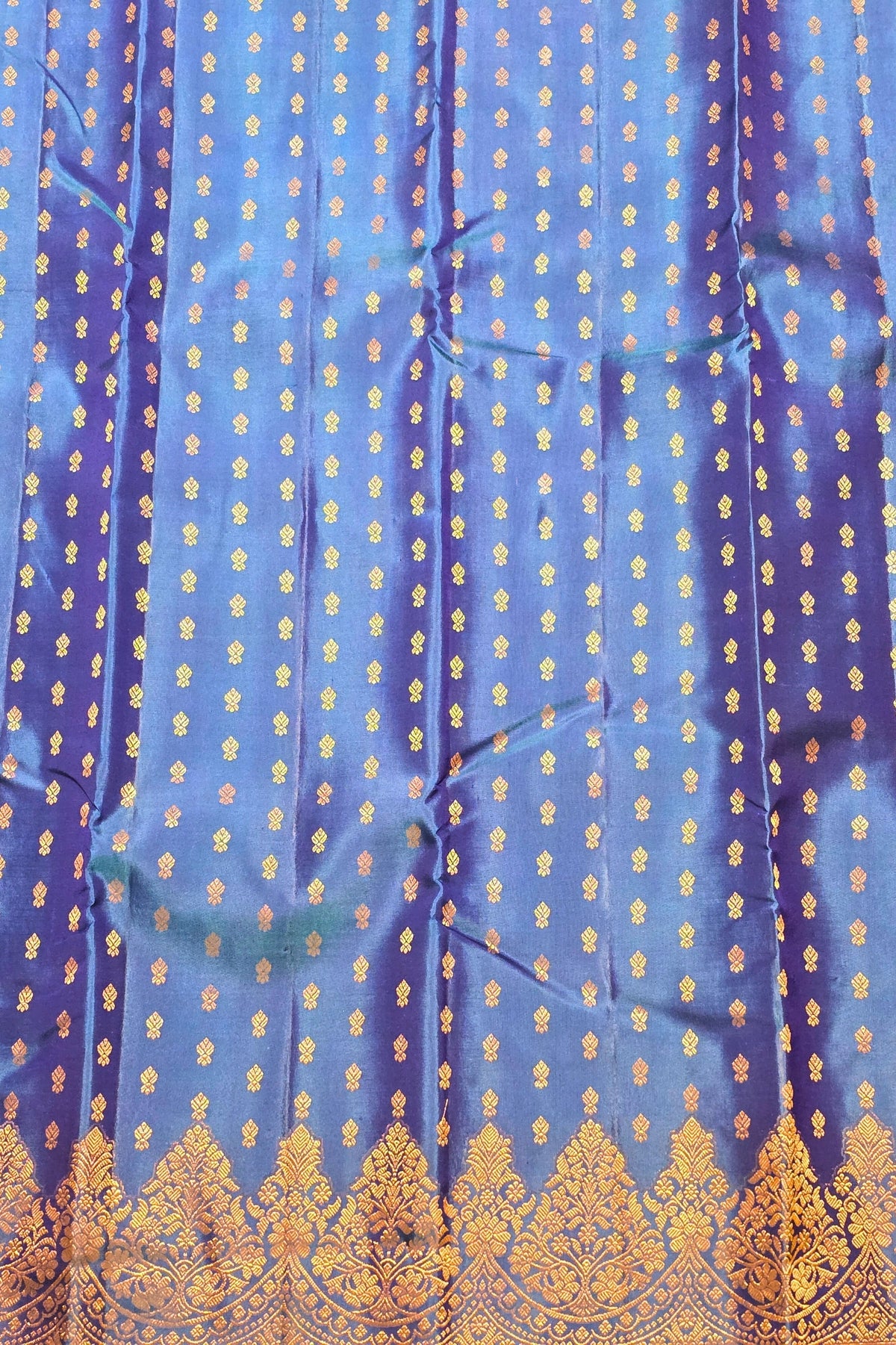Blue fabric with gold patterns and embroidery