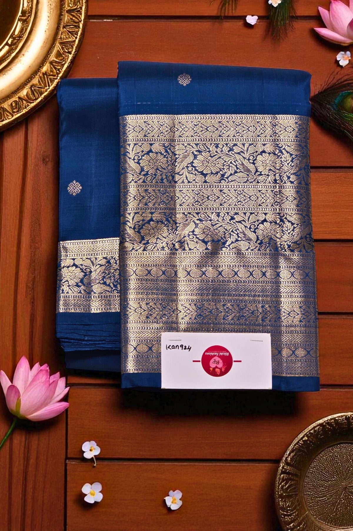 Blue saree with white patterns on a wooden surface with decorative elements