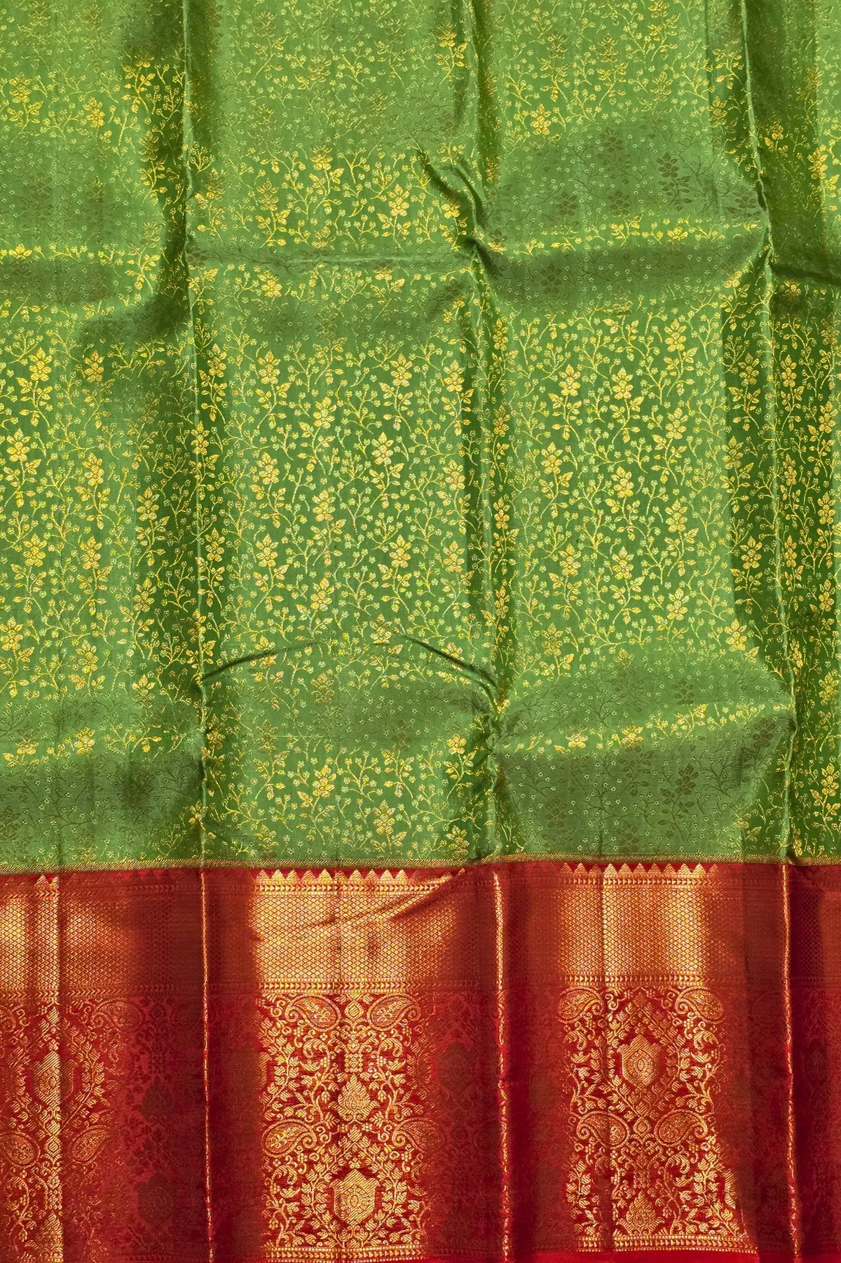 Green and red traditional fabric with intricate patterns