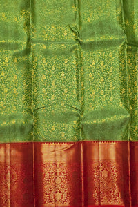 Green and red traditional fabric with intricate patterns