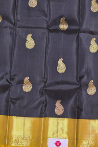 Dark blue fabric with gold paisley patterns and a yellow border.