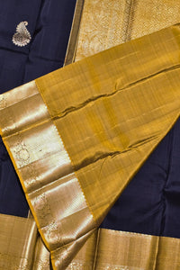 Gold saree with a blue blouse piece on a matching fabric background