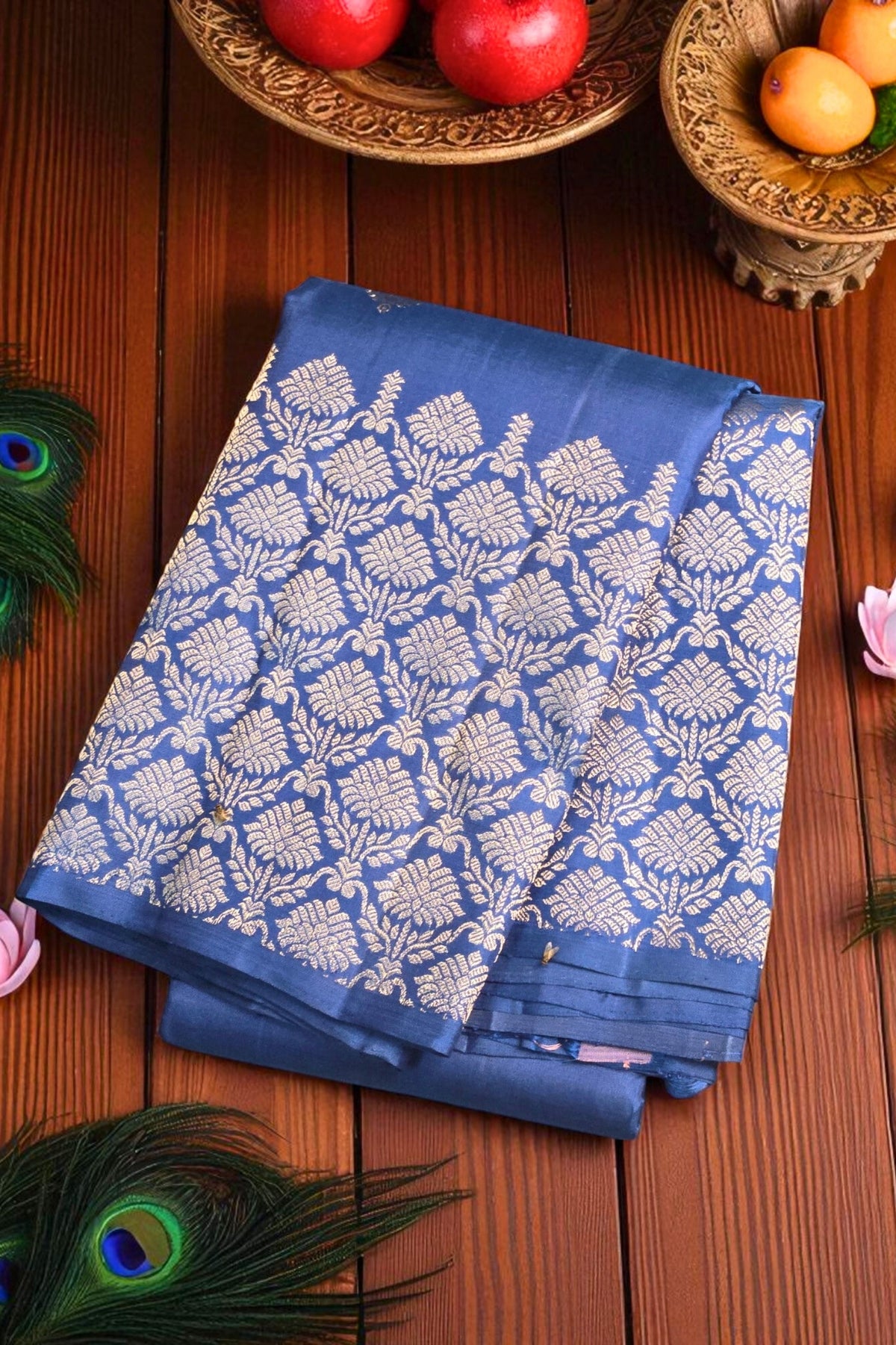 Blue saree with white floral pattern on a wooden surface