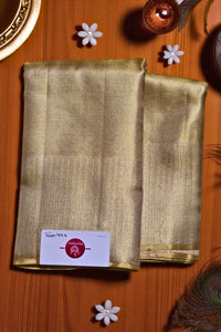 Gold fabric with a label on a wooden surface