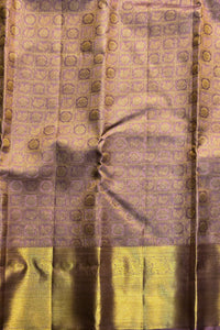 Silk saree with a patterned design on a purple and green background