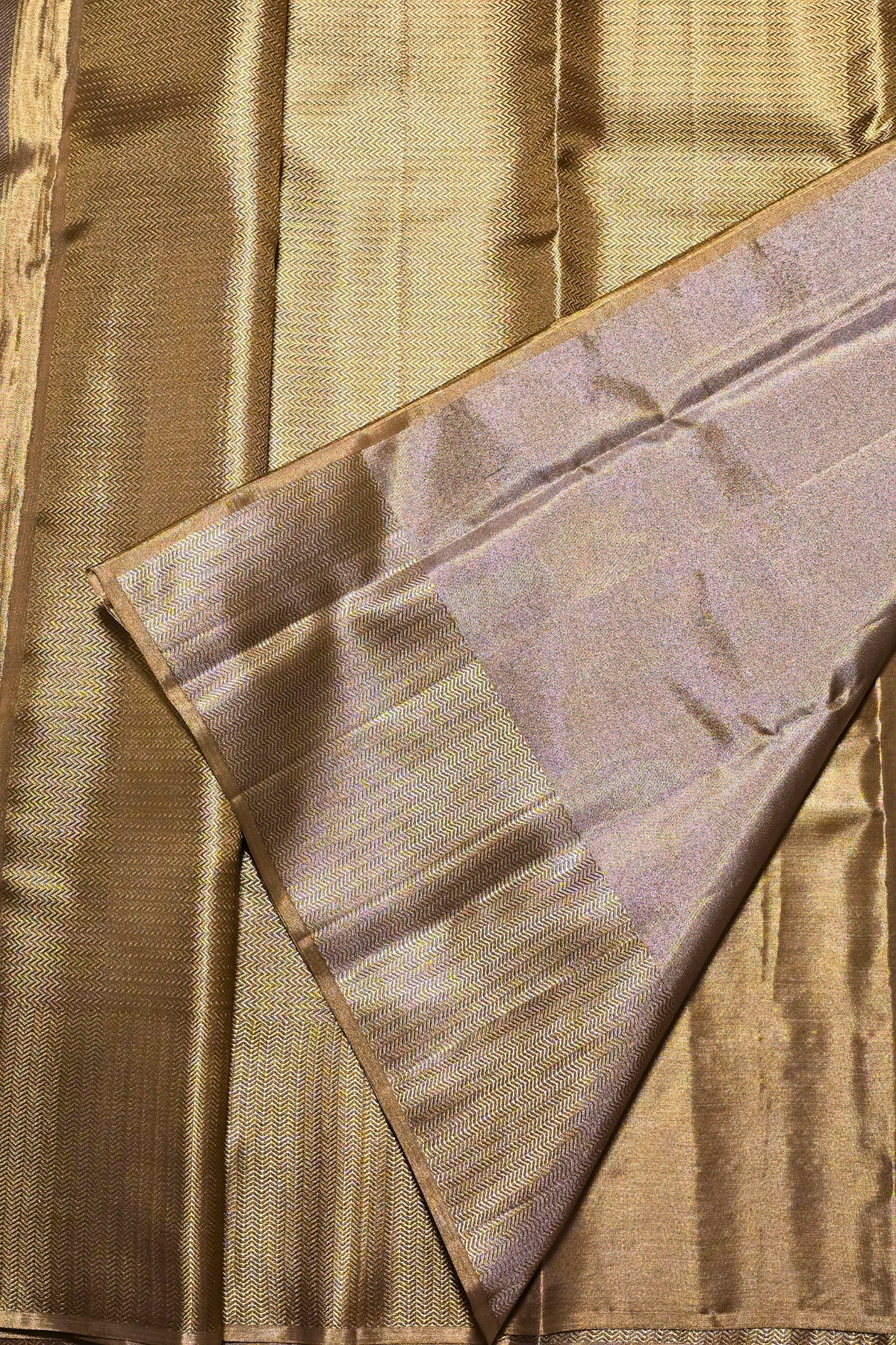 Close-up of gold fabric with a textured pattern