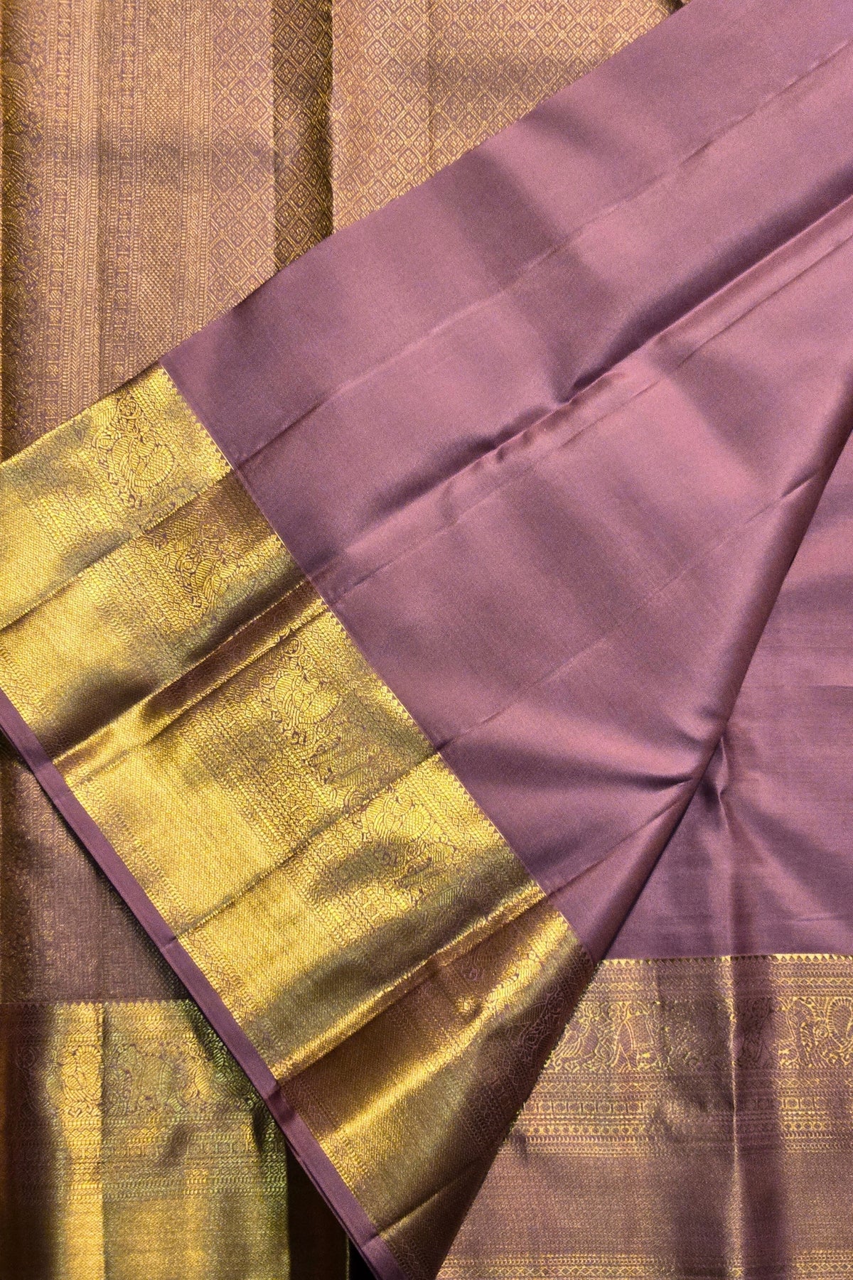 Purple fabric with gold border on a brown background