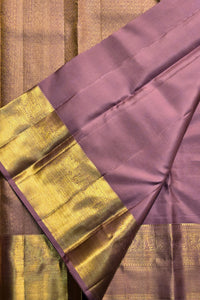 Purple fabric with gold border on a brown background