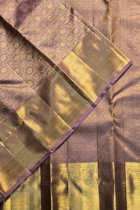 Close-up of a saree with a patterned border and checkered design.