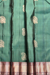 Teal fabric with gold embroidery and border