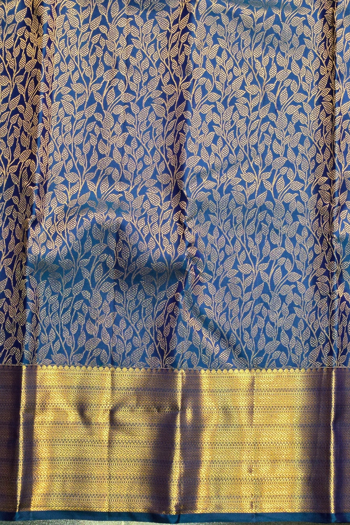 Blue and gold traditional fabric with leaf pattern
