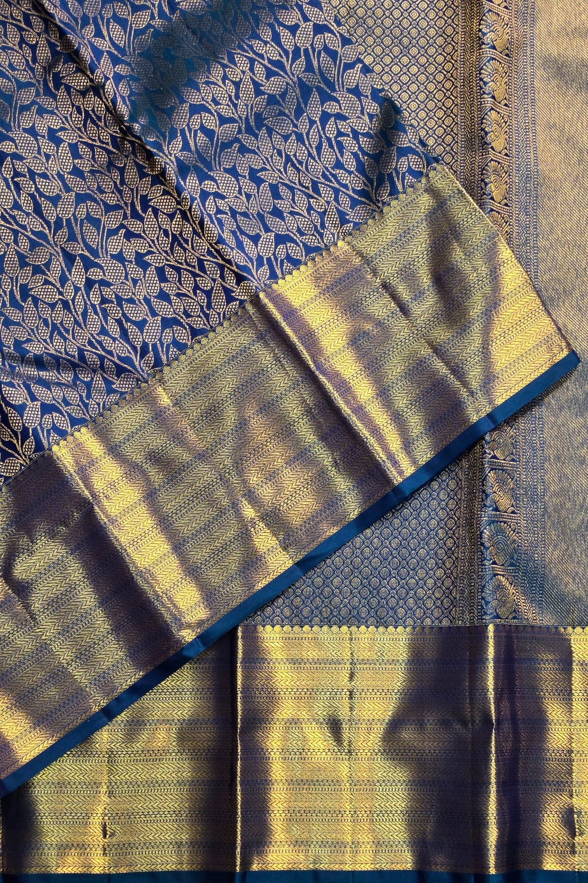 Close-up of a traditional saree with blue and yellow patterns