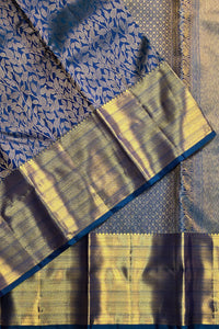 Close-up of a traditional saree with blue and yellow patterns
