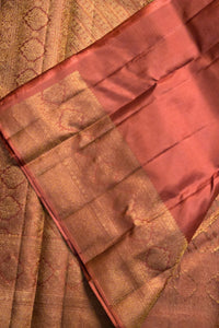 Close-up of a fabric with a textured pattern, possibly a sari or a similar type of textile.