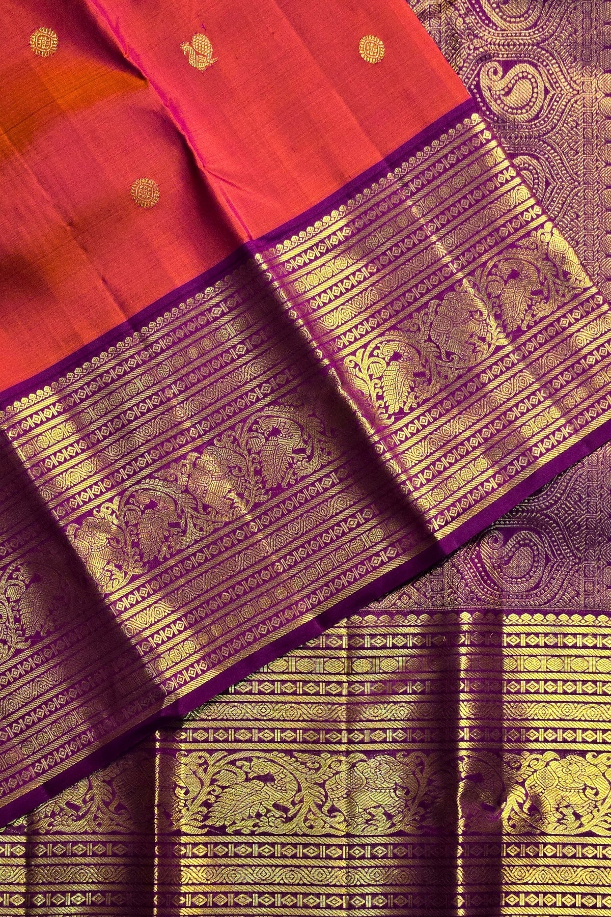 Red and purple saree with gold elephant patterns
