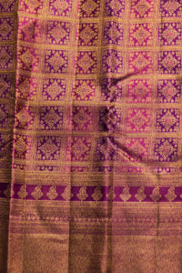 Close-up of a fabric with intricate purple and gold pattern