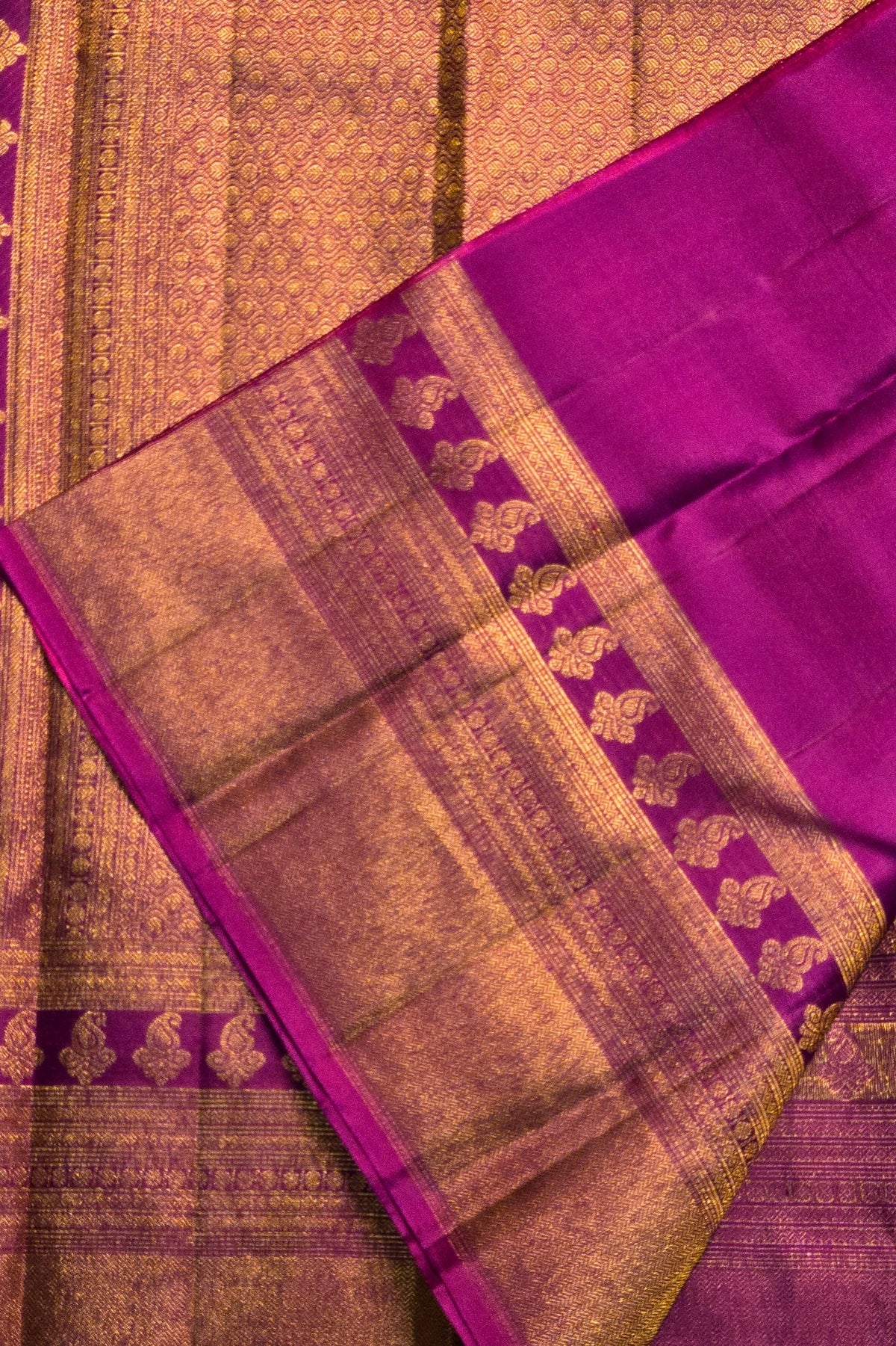 Purple and gold traditional fabric with intricate patterns