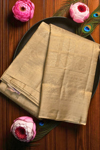 Beige fabric on a black plate with pink flowers and peacock feathers on a wooden background