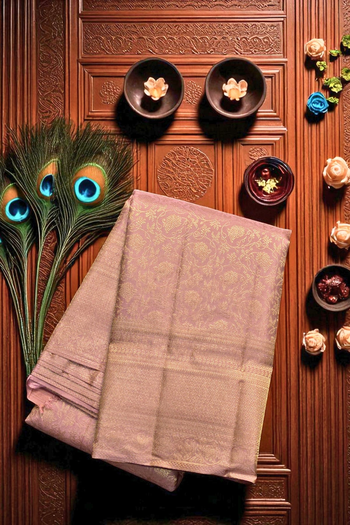 Folded saree on a wooden surface with decorative elements