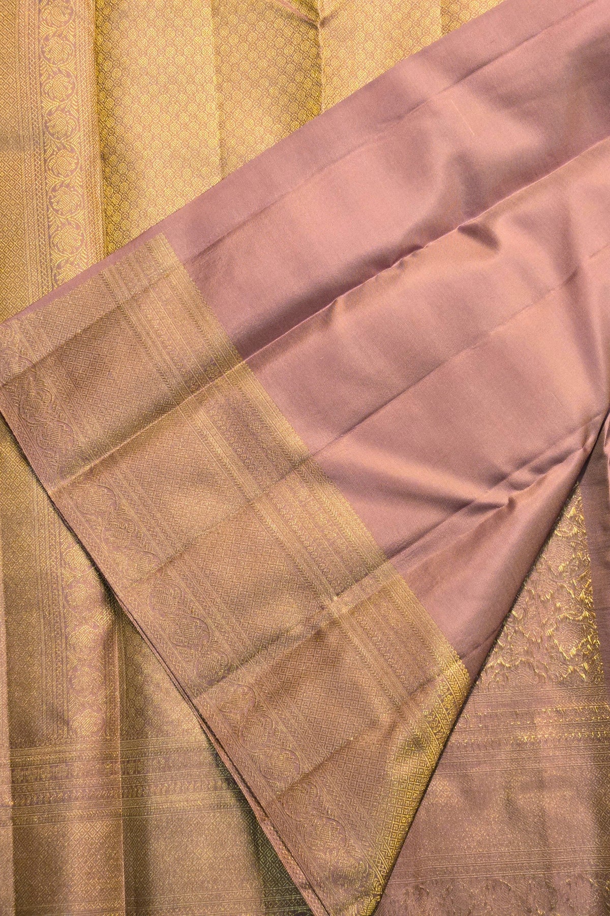 Close-up of a saree with a checkered pattern and gold border