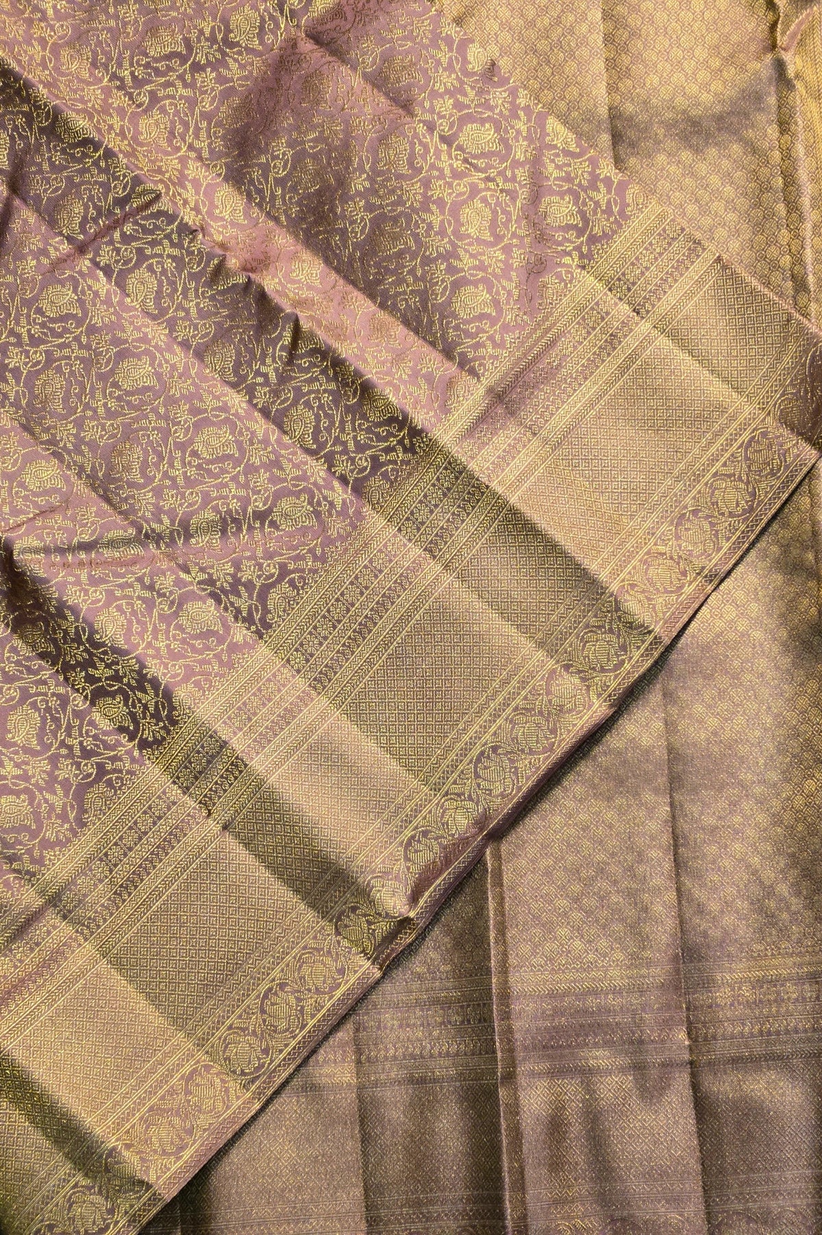 Close-up of a patterned fabric with green and purple tones