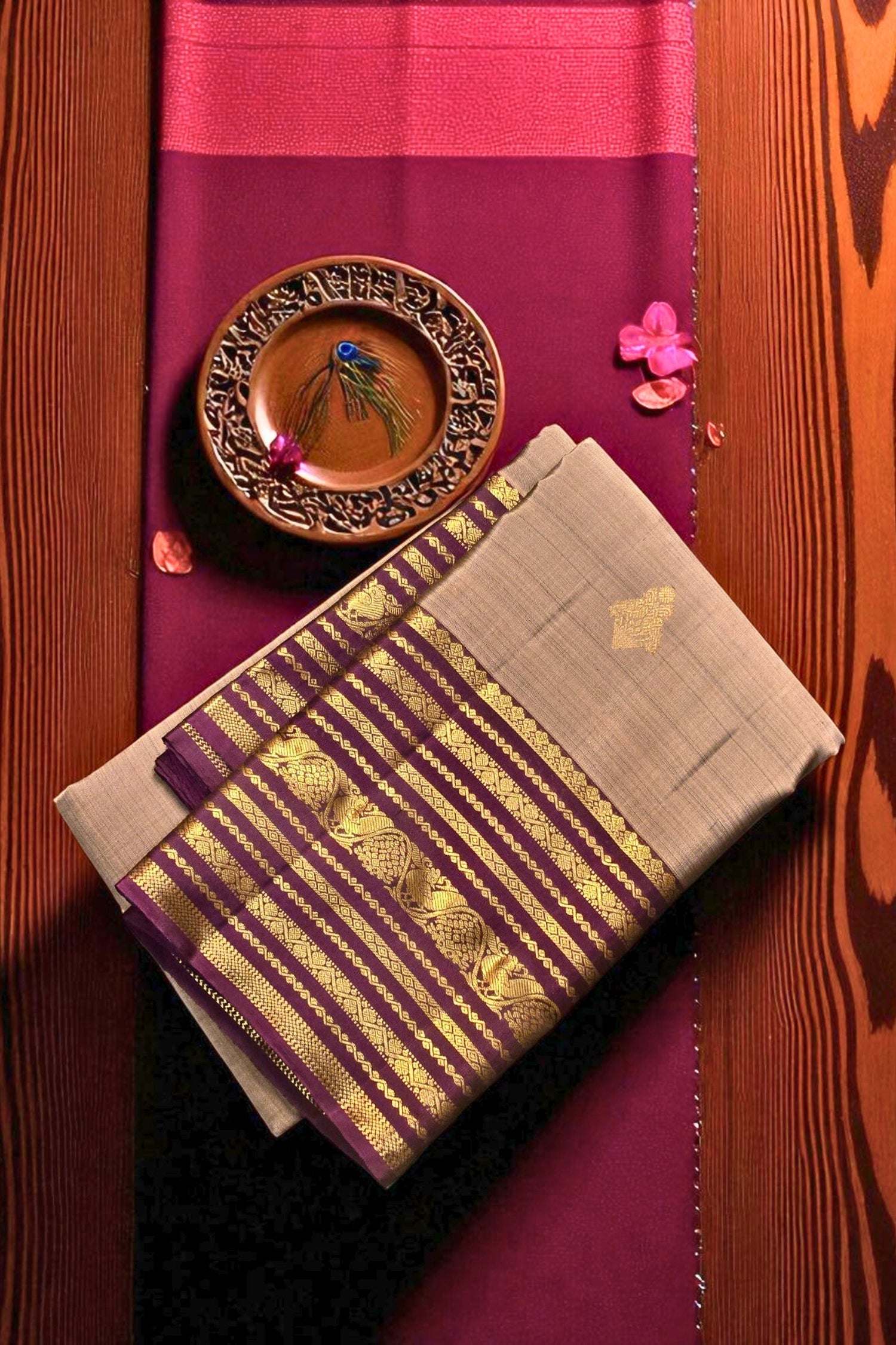 Traditional fabric with gold patterns on a wooden surface