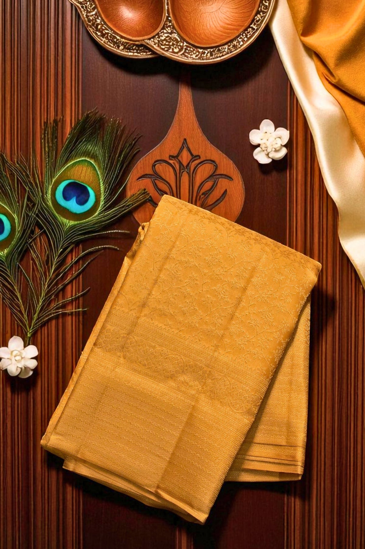 Mustard yellow fabric with peacock feathers and decorative elements on a brown background