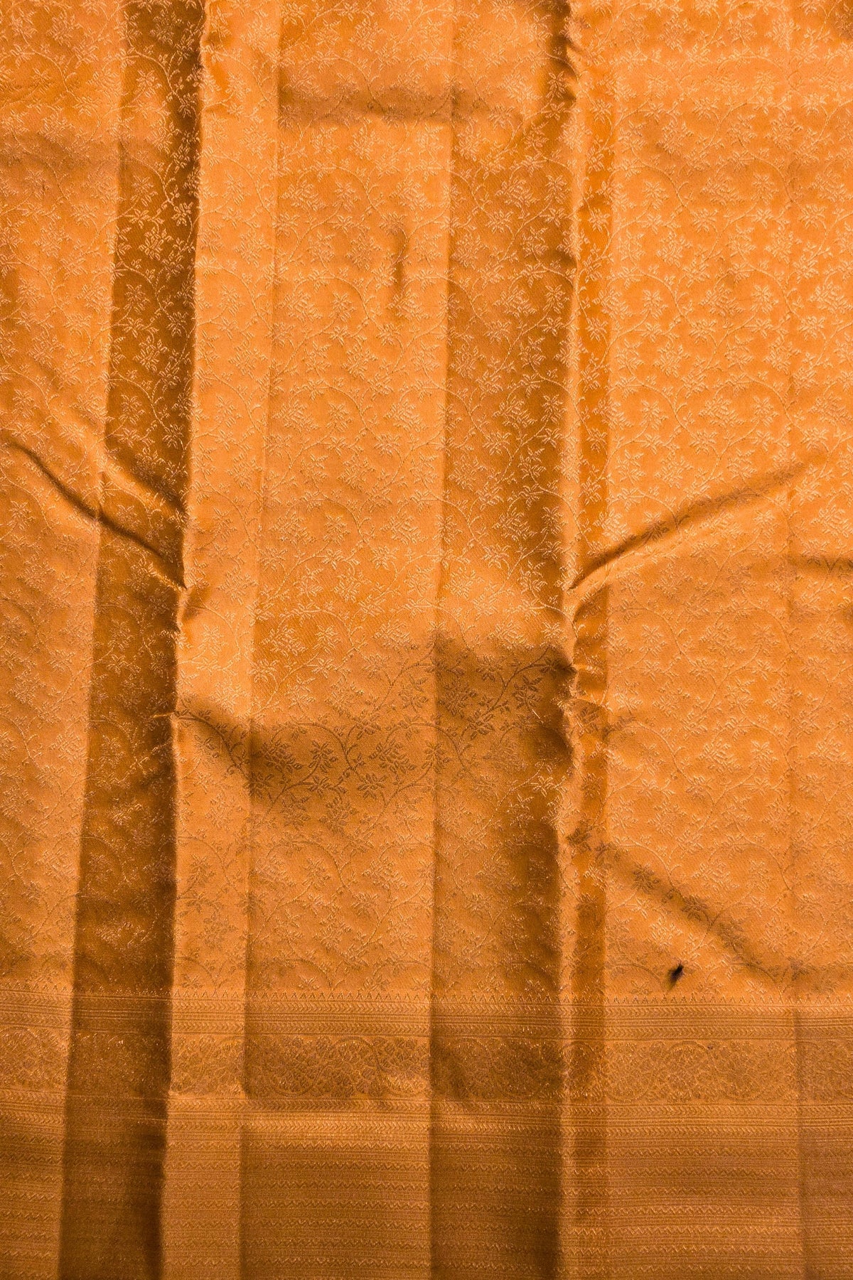Close-up of orange fabric with visible texture