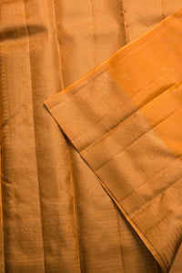 Close-up of a folded piece of orange fabric with a textured pattern.