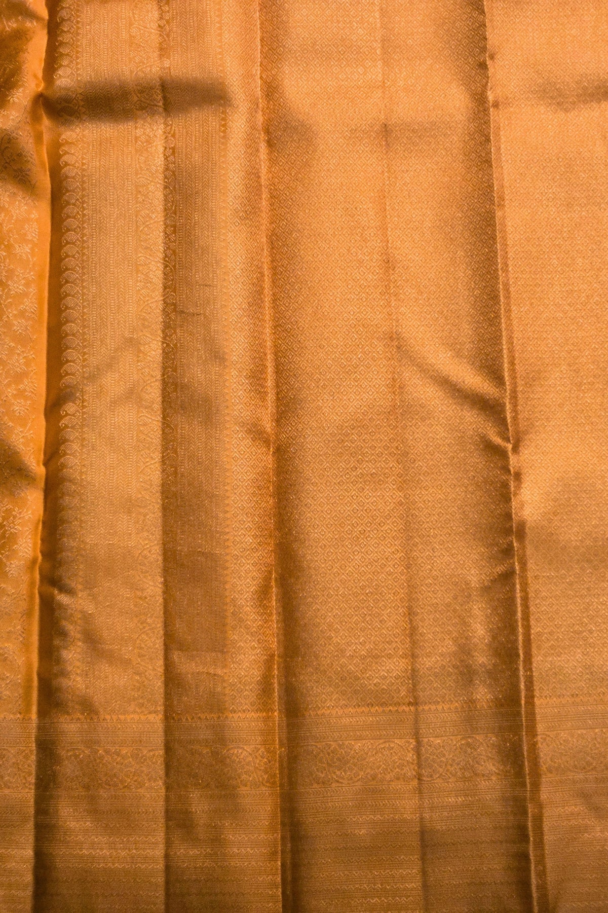 Close-up of orange fabric with a subtle pattern