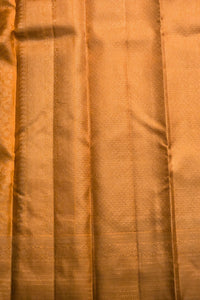 Close-up of orange fabric with a subtle pattern
