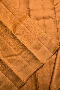 Close-up of a folded piece of gold fabric with a textured pattern.