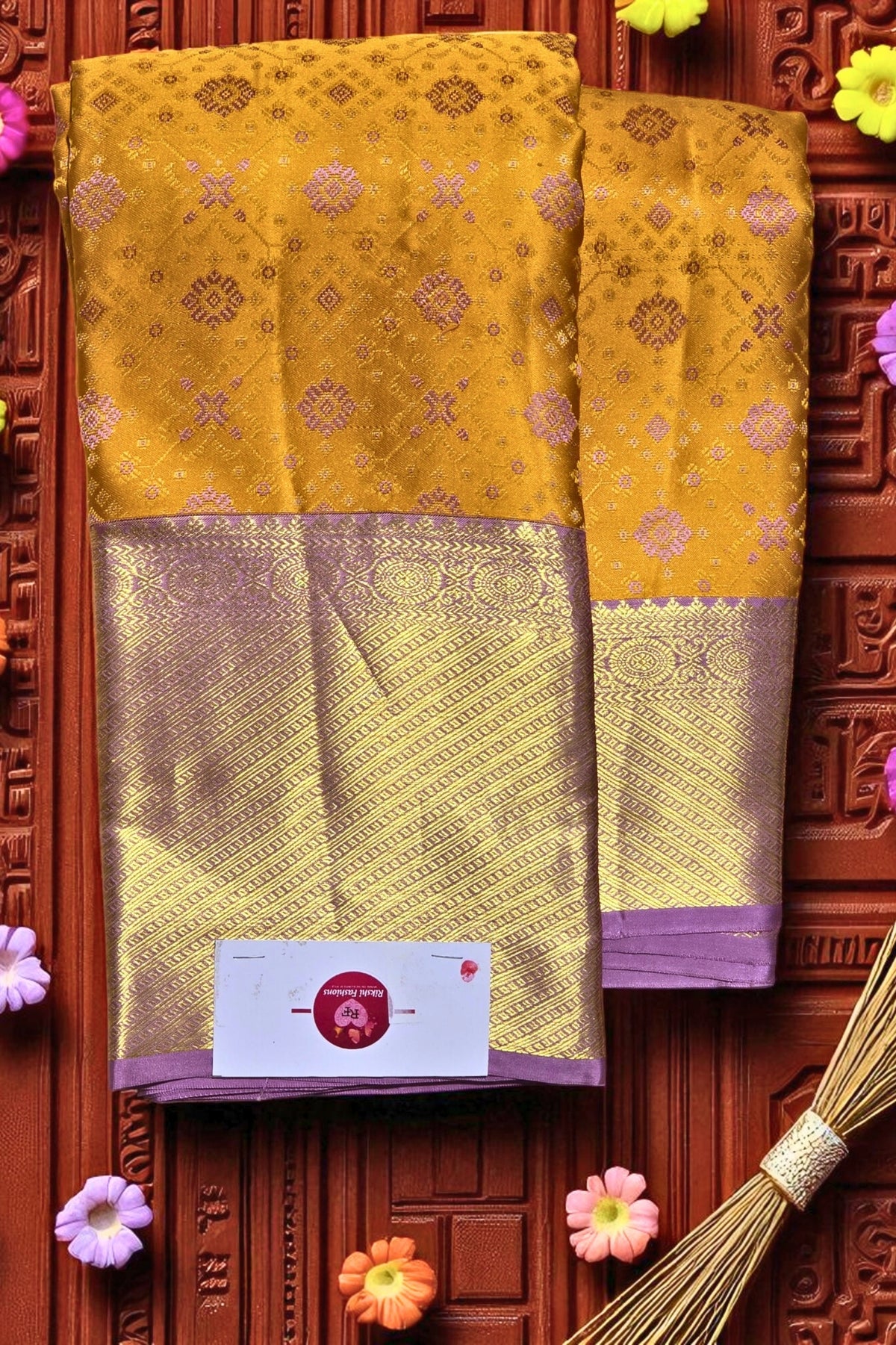 Yellow saree with purple border on a decorative wooden background