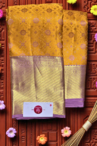 Yellow saree with purple border on a decorative wooden background