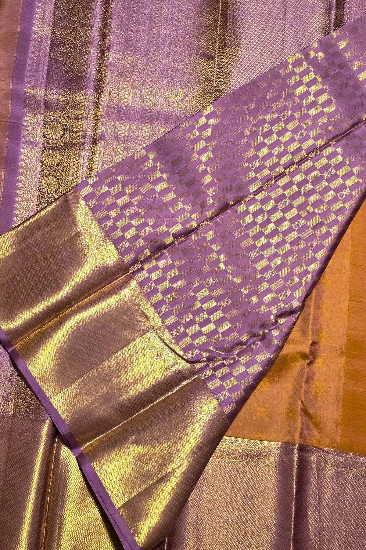 Close-up of a purple and gold fabric with intricate patterns