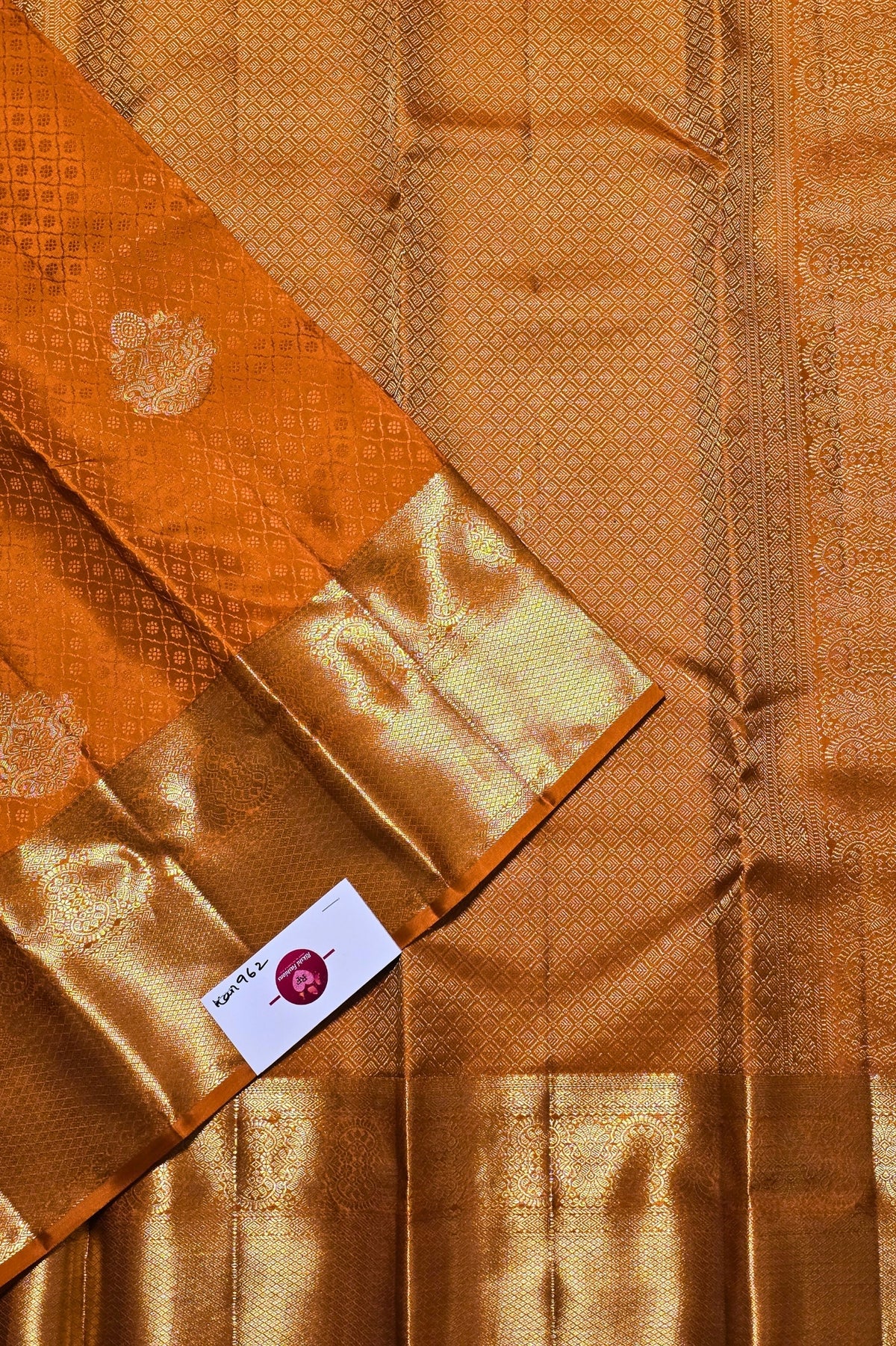 Brown fabric with a pattern and a visible brand label.