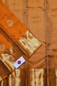 Brown fabric with a pattern and a visible brand label.
