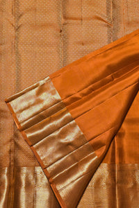 Close-up of a brown saree with a decorative border