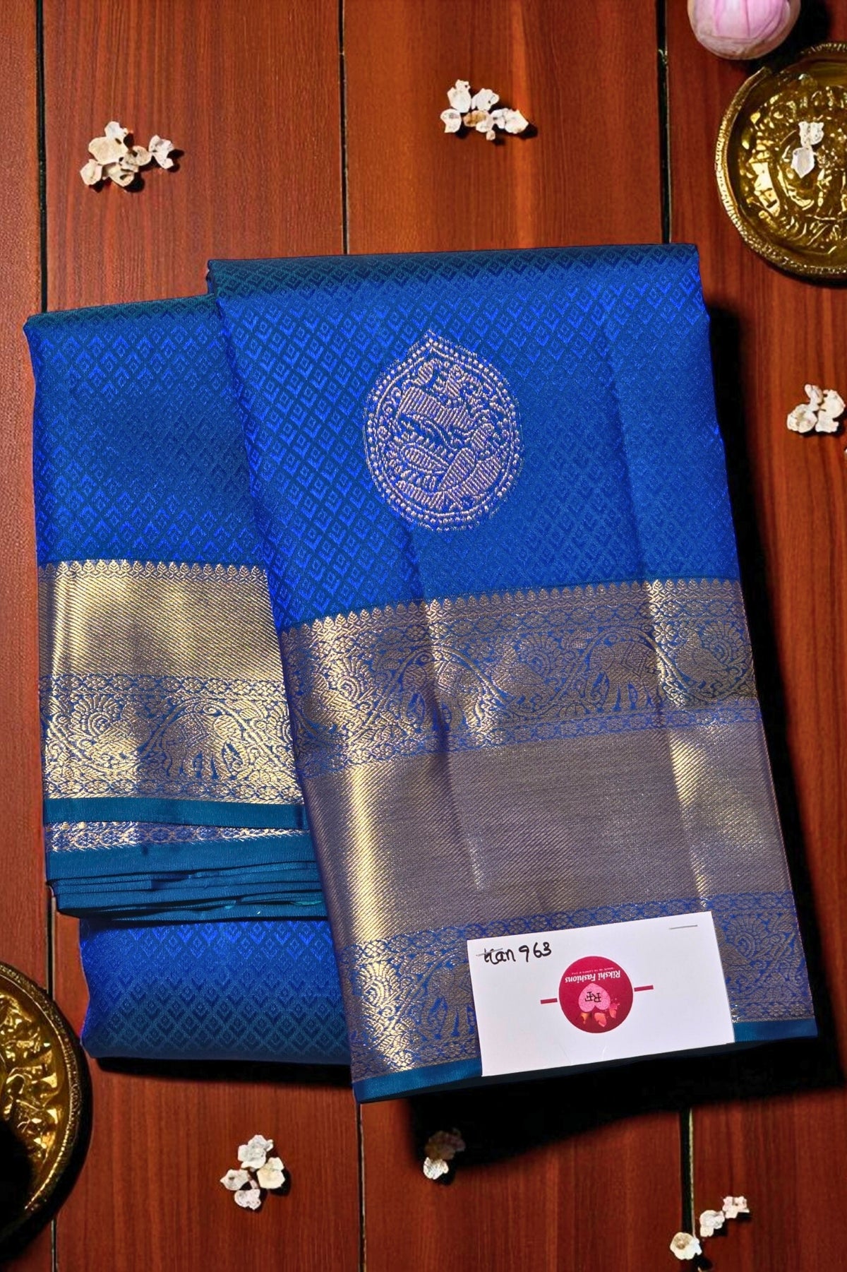 Blue saree with silver border on a wooden background